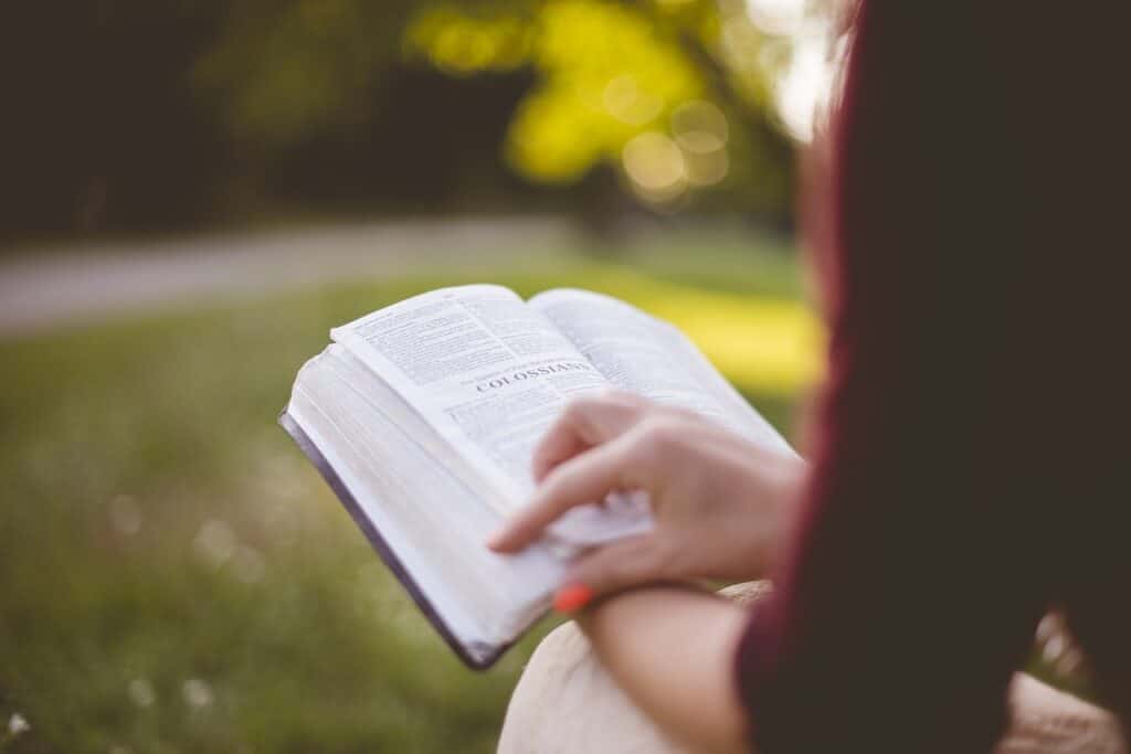 This photo is a picture of a girl reading her bible.