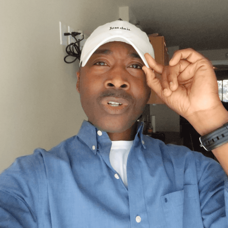 This is a photo of myself wearing a baseball cap, with a light blue colored shirt.